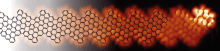 Figure of Scanning tunneling microscopy image resolving the hexagonal structure (schematically indicated by black lines) of one of the studied GNRs. The bright, localized feature at the right side reveals the emergent “exotic” state at the end of the ribbon.